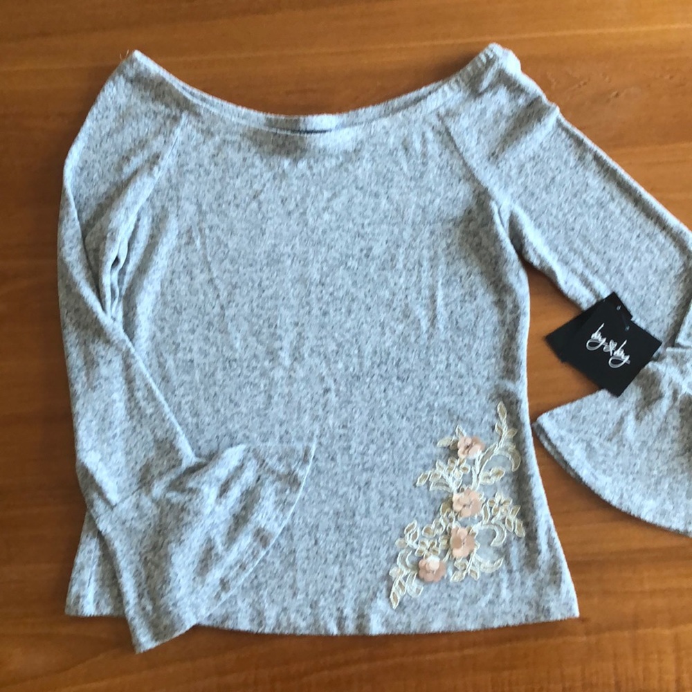 Heather grey sweater with embellishment.